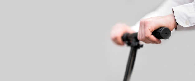 Free photo close-up man riding scooter with copy space