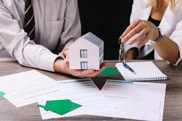 Free photo realtor giving keys to new owner